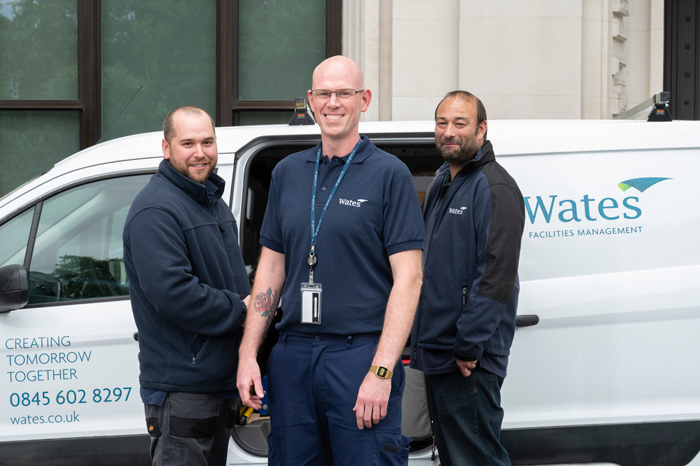 Wates FM workers in front of a company van
